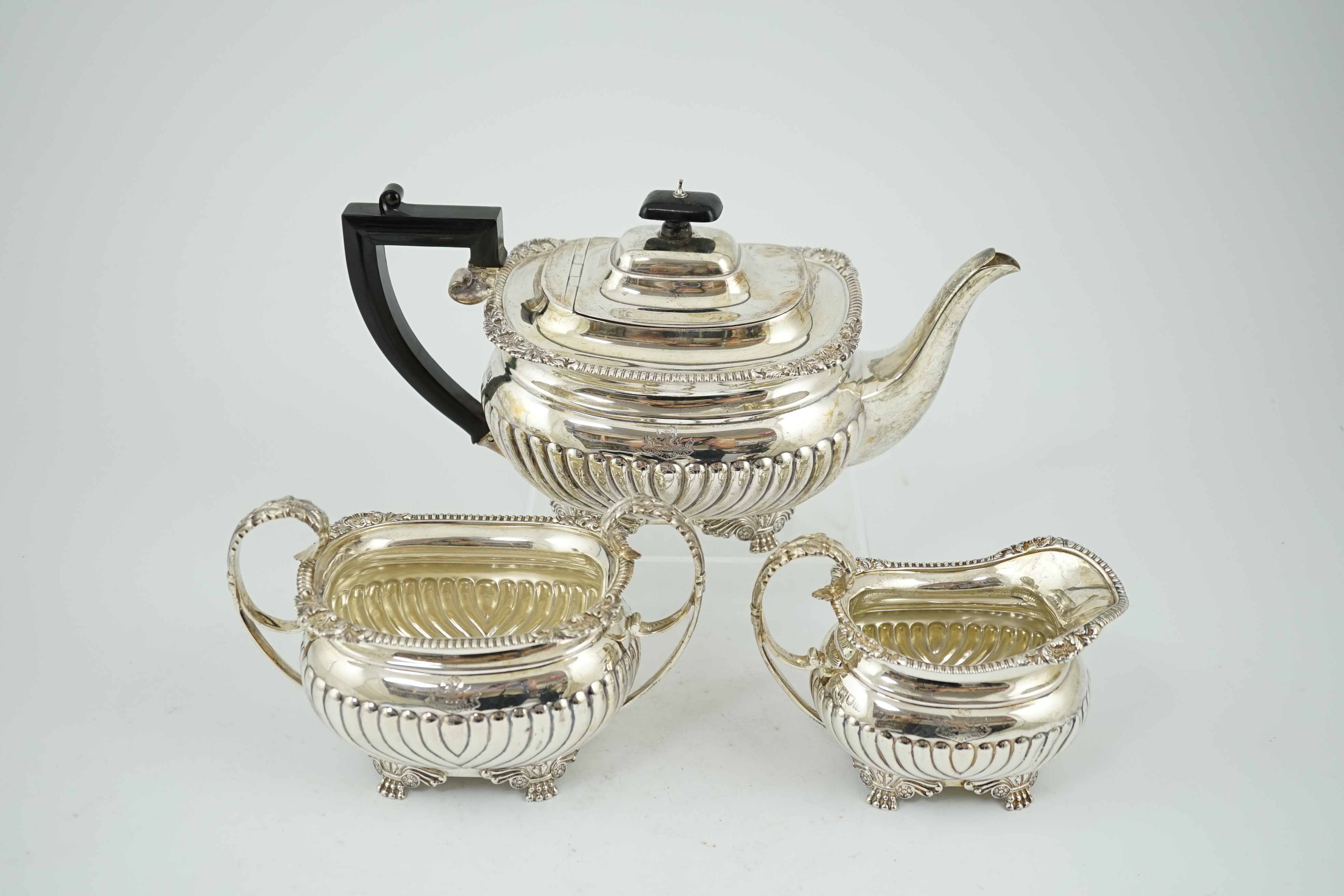 A late Victorian demi fluted silver three piece tea set, by The Barnards